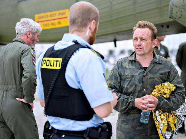 Peter Madsen (right) talks to a police officer in Dragoer Harbor south of Copenhagen on Friday after his rescue. Picture: AFP / Scanpix Denmark / Bax Lindhardt / Denmark