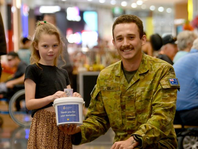 Indie Lowe, 9, with Private Daniel from 1RAR at Willows Shopping Centre. Picture: Evan Morgan