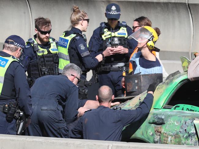 Police surround the protester. Picture: David Crosling