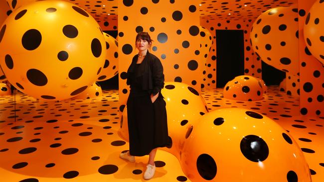 Nicole Durling, Mona co-director of exhibitions and collections, with artwork <i>Dots Obsession Tasmania </i>by Japanese artist Yayoi Kusama. Picture: NIKKI DAVIS-JONES