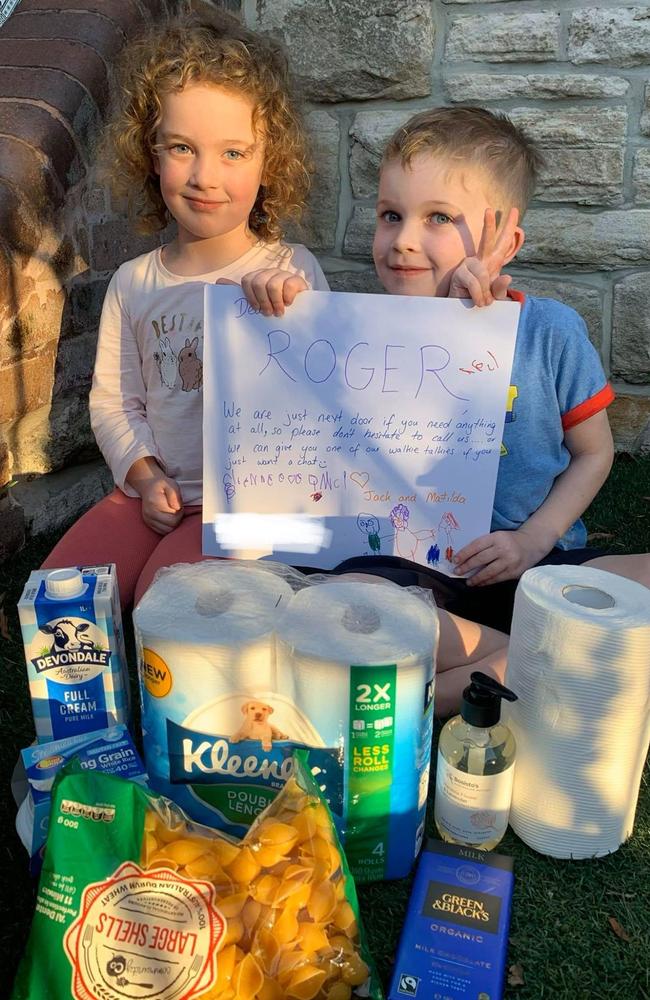 Jack, 5, and Matilda, 4, with their gift package for their neighbour Roger and a note that reads: ‘We are just next door if you need anything.’