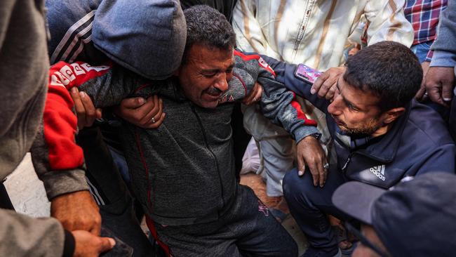 Palestinians tend to a man injured in Israel’s latest strikes on Gaza despite the ongoing ceasefire.
