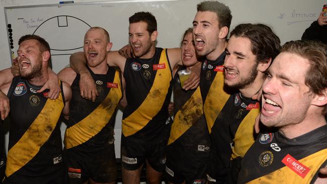 Heidelberg players sing the song after a win over Greensborough. Picture: Chris Eastman