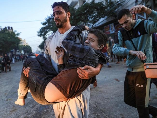 Palestinians help a boy injured in an Israeli strike in Rafah in the southern Gaza Strip. Picture: AFP