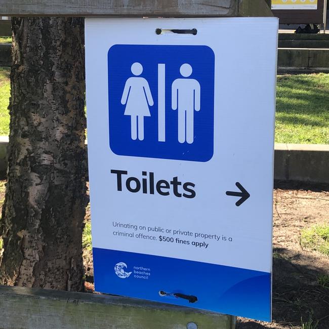 A Northern Beaches Council sign in East Esplanade Park advising the public there is a $500 fine for urinating in a public or private place and that the act is a criminal offence. Picture: Jim O’Rourke