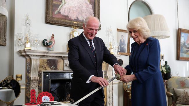 Queen Camilla cut the cake with a ceremonial sword while marking the 100th anniversary of a veteran’s charity. Picture: Getty Images