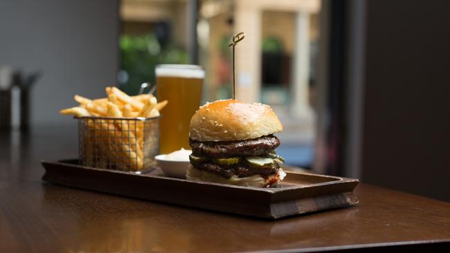 The Port Office Hotel wagyu burger with tomato, Swiss cheese, cos, pickles, onion jam, club sauce and fries.