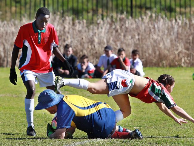 The teachers’ goalkeeper stops a move.