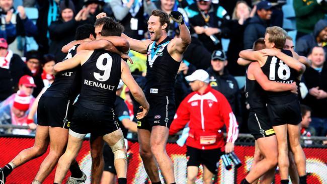 Port Adelaide players celebrate an upset win over the Sydney Swans at AAMI Stadium. 