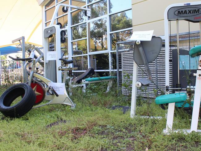 Disused gym equipment dumped outside.