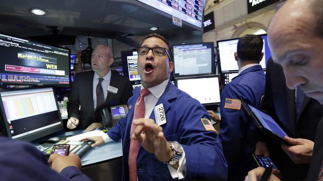 Pure chaos ... Specialist Paul Cosentino works with traders on the floor of the New York Stock Exchange. Picture: AP