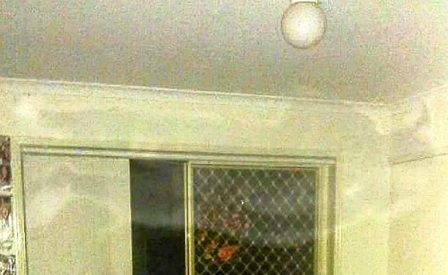 An eerie figure appears to be floating near the ceiling in this photo which was taken with a phone-camera. Picture: Contributed