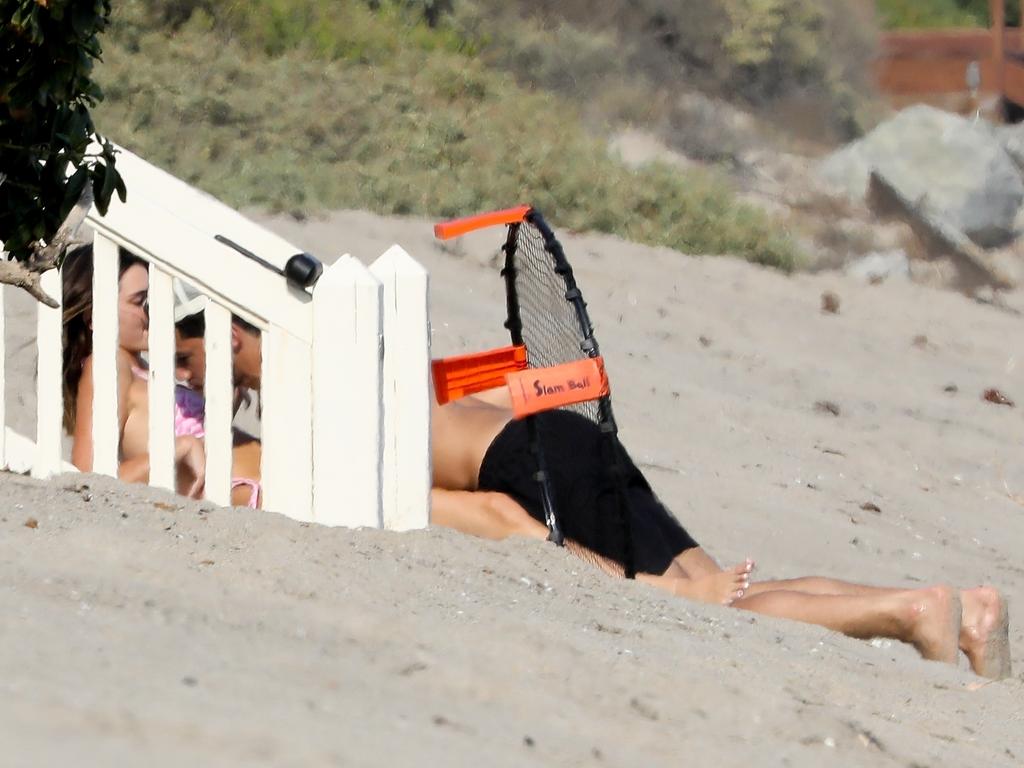 Kendall Jenner and Devin Booker appear to confirm their romance as the Phoenix Suns player is seen laying on top of Kendall as the pair enjoyed a beach day in Malibu. Picture: RAAK/BACKGRID