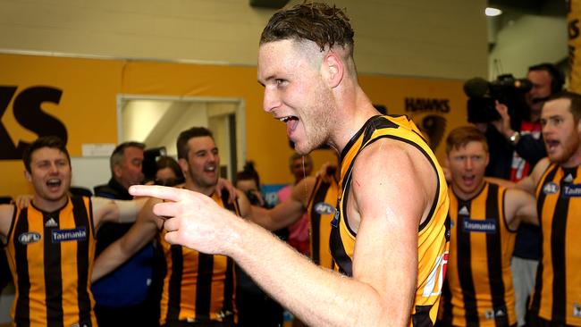 Luke Lowden sings the club song in the middle of the Hawthorn players’ circle after his AFL debut – and only game for the Hawks in 2014. Picture: Wayne Ludbey