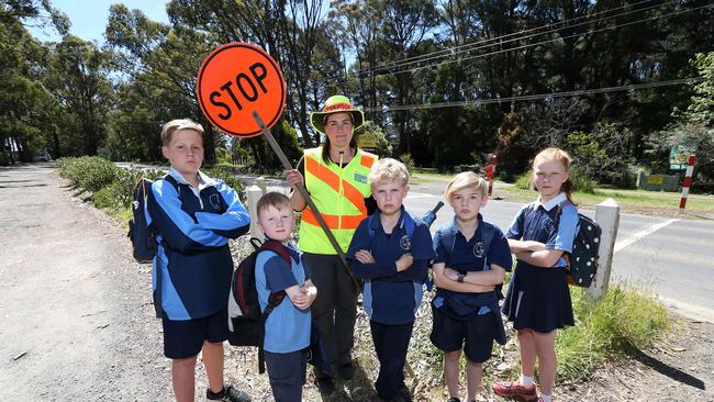 Doris Mullis and Kinglake West Primary students Aiden, Oliver, Carl, Josh and Evelyn want a safe passageway to and from their school. Picture: George Salpigtidis