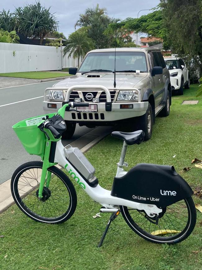 Cars with tickets on their windshields and a Lime bike outside Stuart Smith's home on Sovereign Drive in Mermaid Waters on Easter Monday.