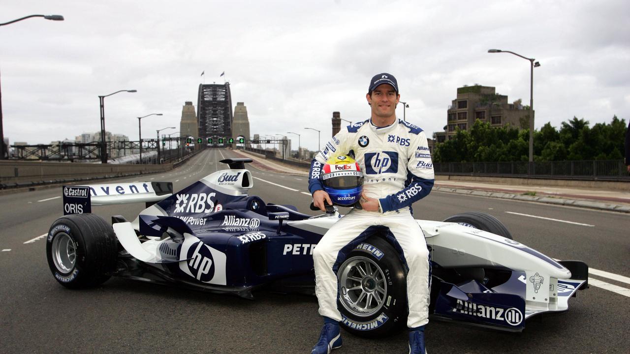 Former F1 driver Mark Webber with his BMW Williams car across the Sydney Harbour Bridge in a promotional event.