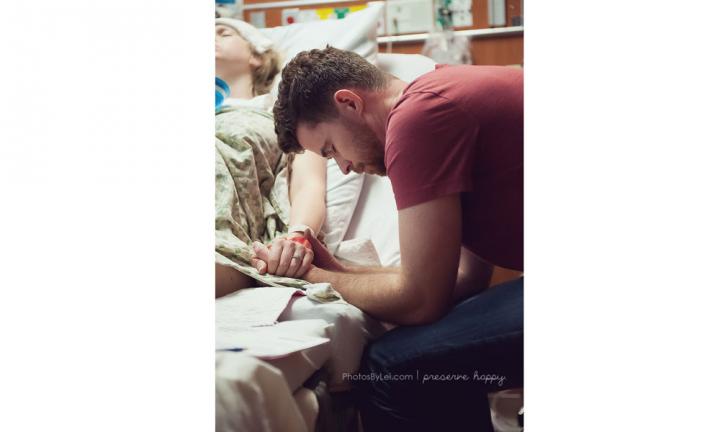 Father praying - This image has gone viral on Pinterest, and I think it's because dads are so rarely captured as part of the process. Here a husband is sweetly praying for his wife during her labor.