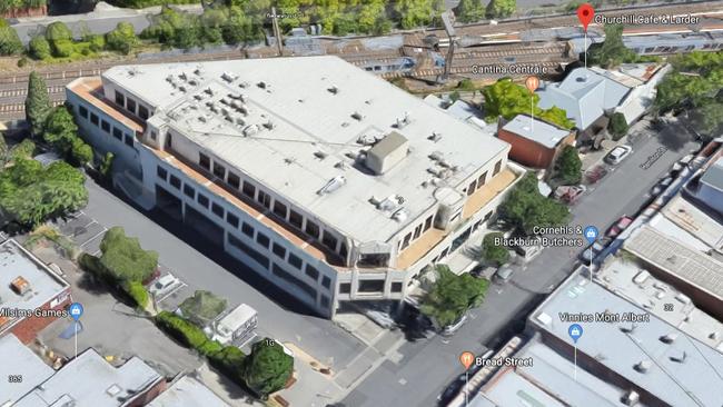 The large building is next to the train line in the centre of Mont Albert Village.