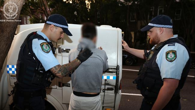 Adam Moule is taken away in a police van. Picture: NSW Police