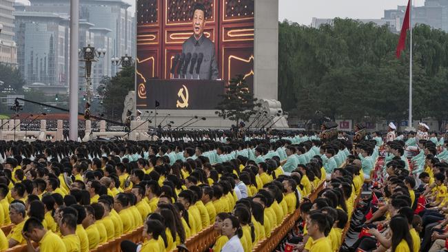 Xi Jinping is seen on a screen as the crowd listens during his speech at a ceremony marking the 100th anniversary of the Communist Party at Tiananmen Square in July. Picture: Getty Images