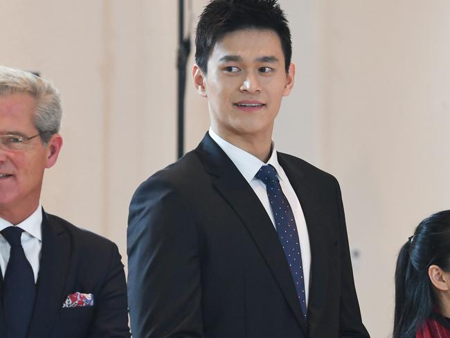 China's swimming star Sun Yang (C), accused of smashing a blood vial with a hammer, arrives to his public hearing before the Court of Arbitration for Sport (CAS) in Montreux on November 15, 2019. - Triple Olympic champion Sun, winner of 11 world titles and a national hero back home, faces an eight-year ban if charges against him are upheld by the Court of Arbitration for Sport. (Photo by jean-guy PYTHON / AFP)