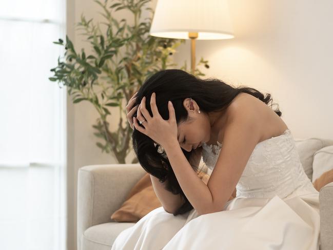 Sad and worried bride crying and arguing with groom in wedding day