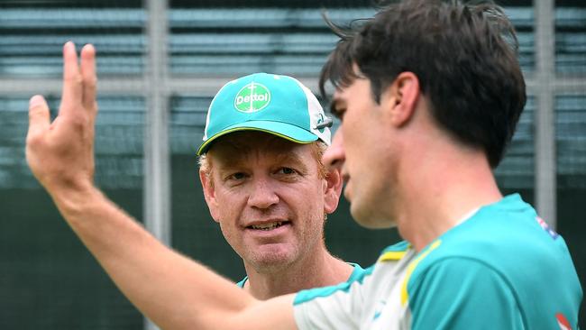 Australian cricket captain Pat Cummins (R) speaks with coach Andrew McDonald.