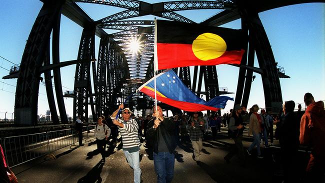 Aboriginal flag carried across Sydney Harbour Bridge during Corroboree 2000 reconciliation march in Sydney.