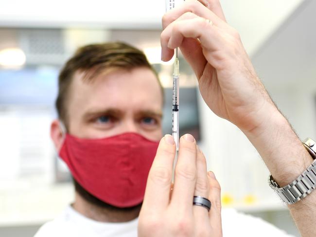 BRISBANE, AUSTRALIA - NewsWire Photos - AUGUST 8, 2021. Pharmacist Michael Thorp draws from a vial of the AstraZeneca Covid-19 vaccine the at the Carina Day and Night pharmacy in Brisbane. Picture: NCA NewsWire / Dan Peled