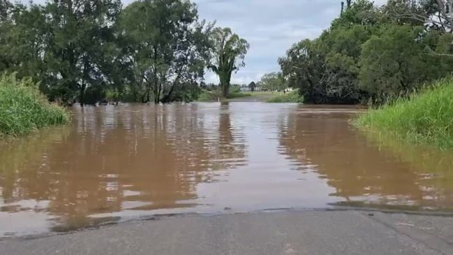 Two rescued from flood waters after car swept off road