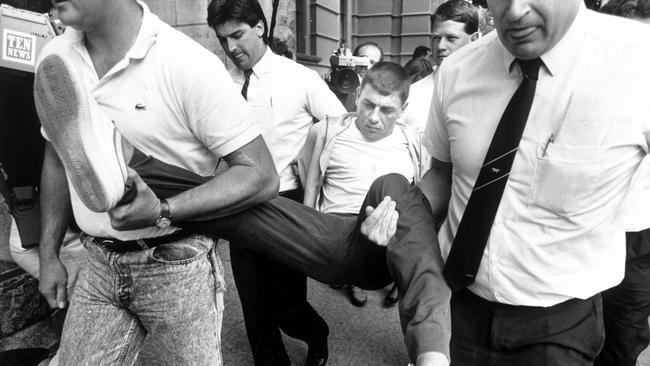 Victor Peirce is carried into court on charges of involvement in Walsh St police killings.