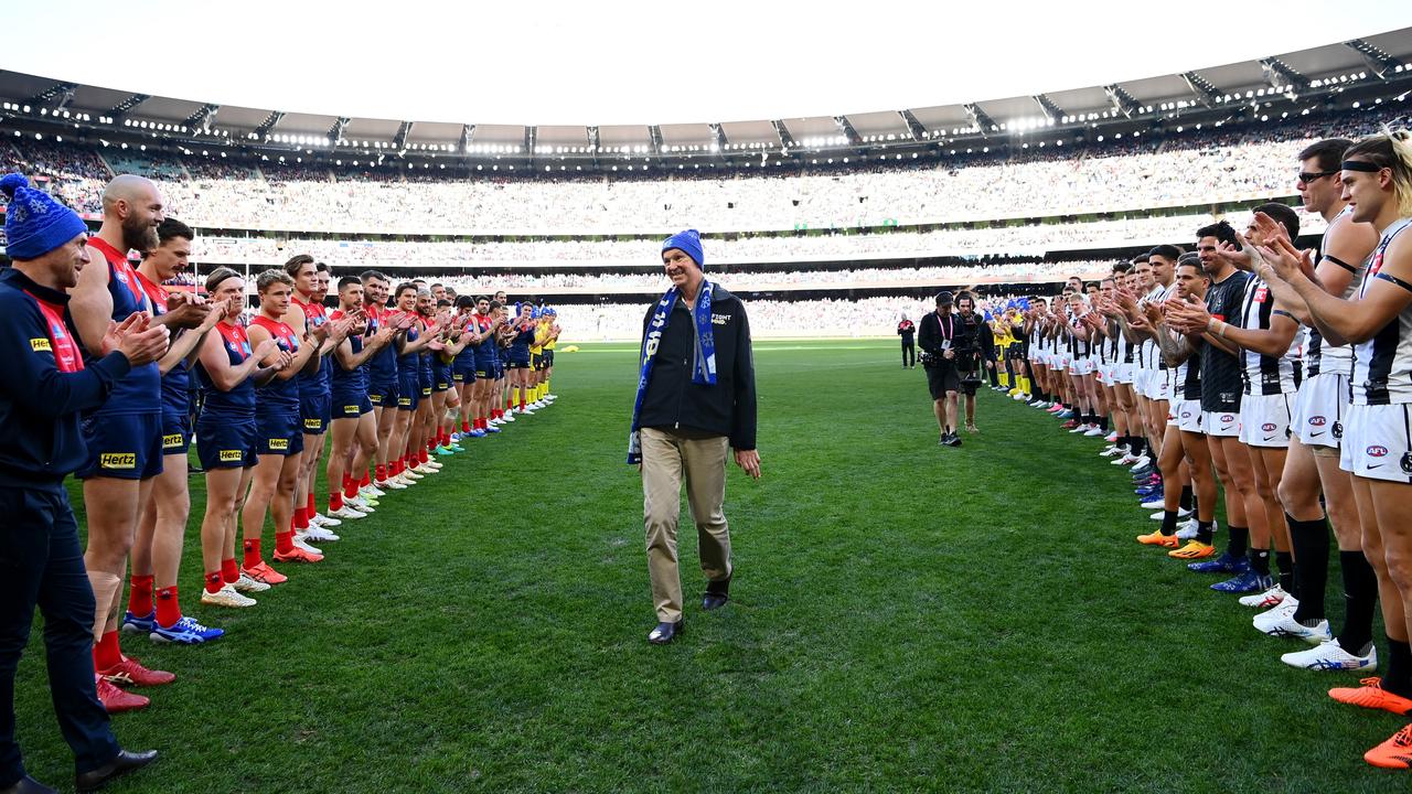 Neale Daniher walks through a guard of honour from Demons and Magpies players. Picture: Quinn Rooney/Getty Images