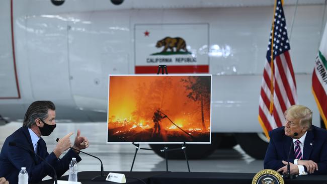 Donald Trump (R) speaks to California Governor Gavin Newsom at Sacramento McClellan Airport in McClellan Park, California. Picture: AFP.