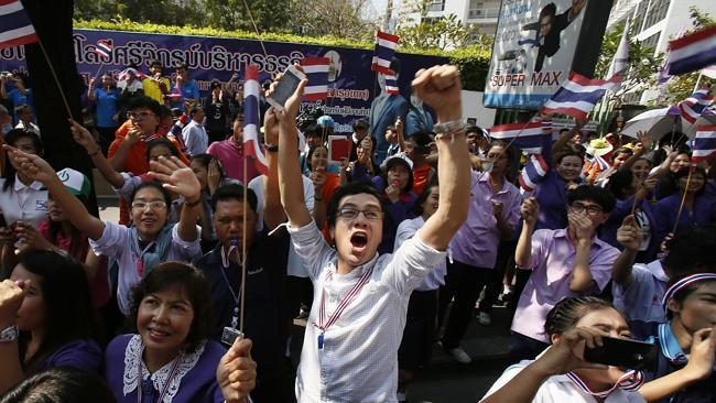 A supporter cheers on a passing anti-government march in Bangkok. Picture: AP