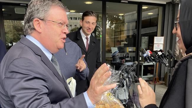 Outgoing ALP MP Frank McGuire hands out tasty treats to journalists on his last day in the job.