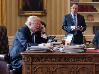 WASHINGTON, DC - JANUARY 28: President Donald Trump speaks on the phone with Russian President Vladimir Putin in the Oval Office of the White House, January 28, 2017 in Washington, DC. Also pictured, from left, White House Chief of Staff Reince Priebus, Vice President Mike Pence, White House Chief Strategist Steve Bannon, Press Secretary Sean Spicer and National Security Advisor Michael Flynn. On Saturday, President Trump is making several phone calls with world leaders from Japan, Germany, Russia, France and Australia. (Photo by Drew Angerer/Getty Images)
