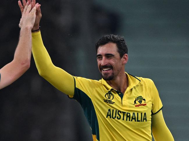 Australia's captain Pat Cummins (L) celebrates with teammate Mitchell Starc after taking the wicket of Sri Lanka's Dunith Wellalage during the 2023 ICC Men's Cricket World Cup one-day international (ODI) match between Australia and Sri Lanka at the Ekana Cricket Stadium in Lucknow on October 16, 2023. (Photo by Arun SANKAR / AFP) / -- IMAGE RESTRICTED TO EDITORIAL USE - STRICTLY NO COMMERCIAL USE --