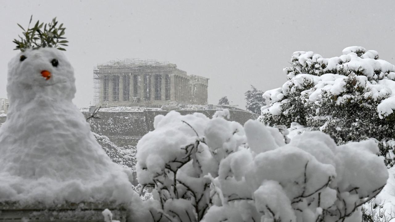 A snowman in front of the Parthenon temple atop the Acropolis in Athens. Picture: Aristotle Messinis/AFP