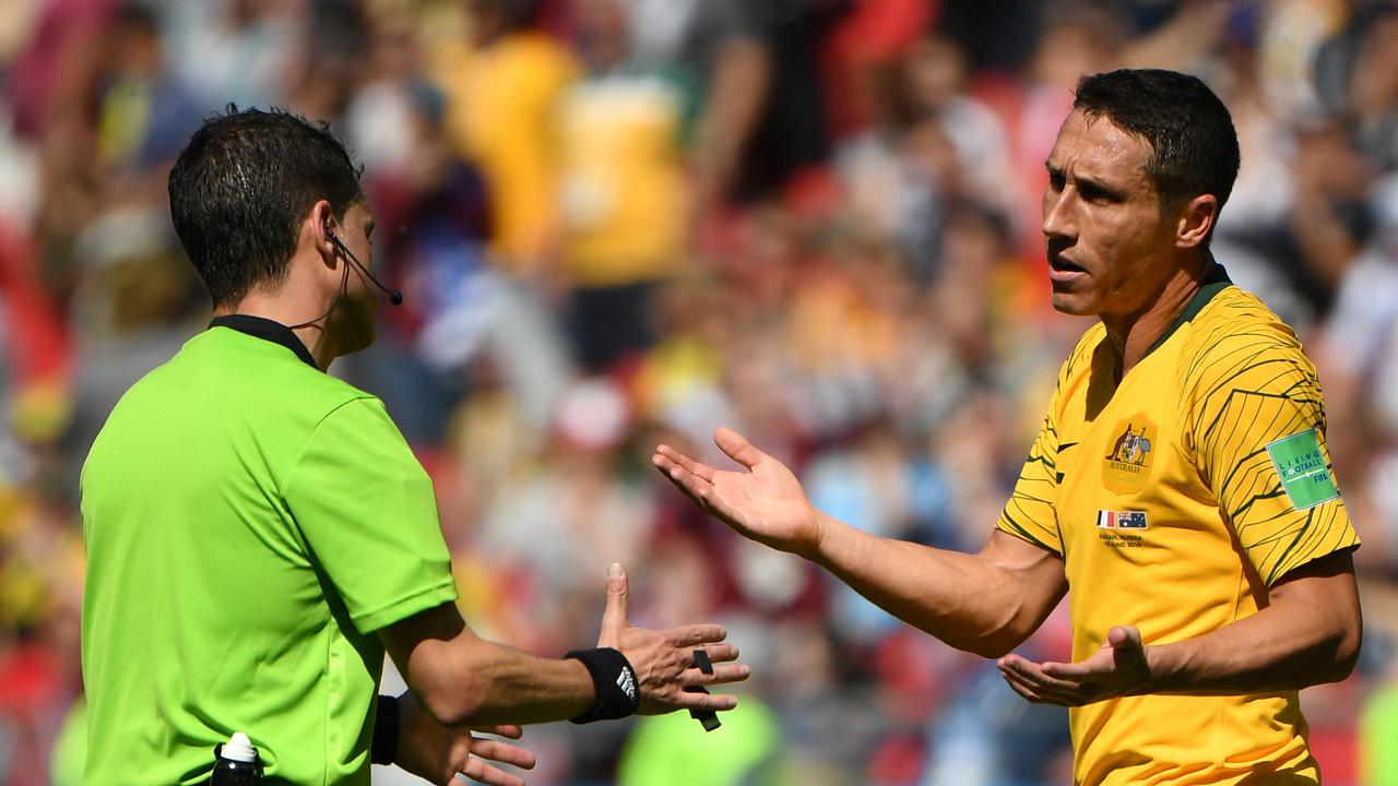 Australia's Mark Milligan argues with match referee Andres Cunha. (AAP Image/Dean Lewins)