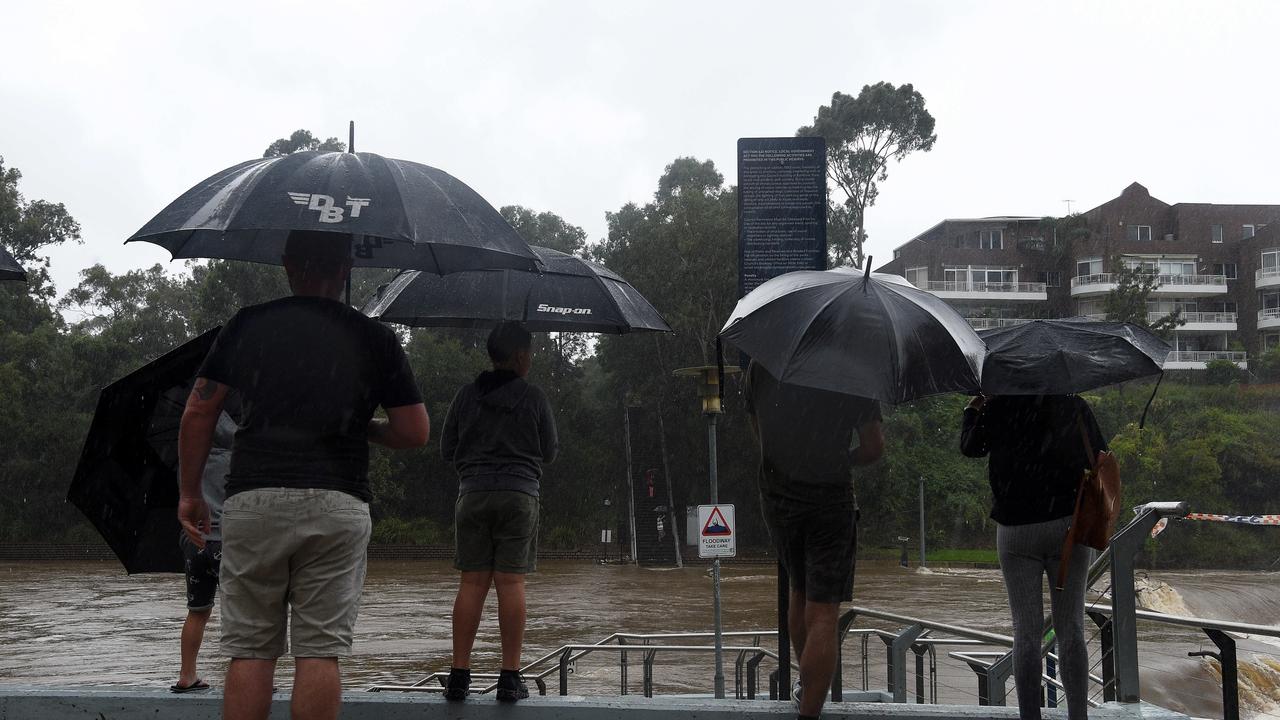 People observing as the Parramatta River overflow in Sydney Picture: NCA NewsWire/Bianca De Marchi