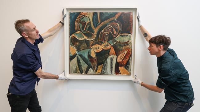 Art handlers Toby Pola and David Mutch place a work by Picasso at the NGV. Picture: David Caird