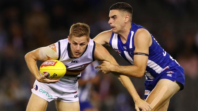 David Mackay of the Crows is tackled by Paul Ahern of the Kangaroos. Picture: Scott Barbour/Getty Images