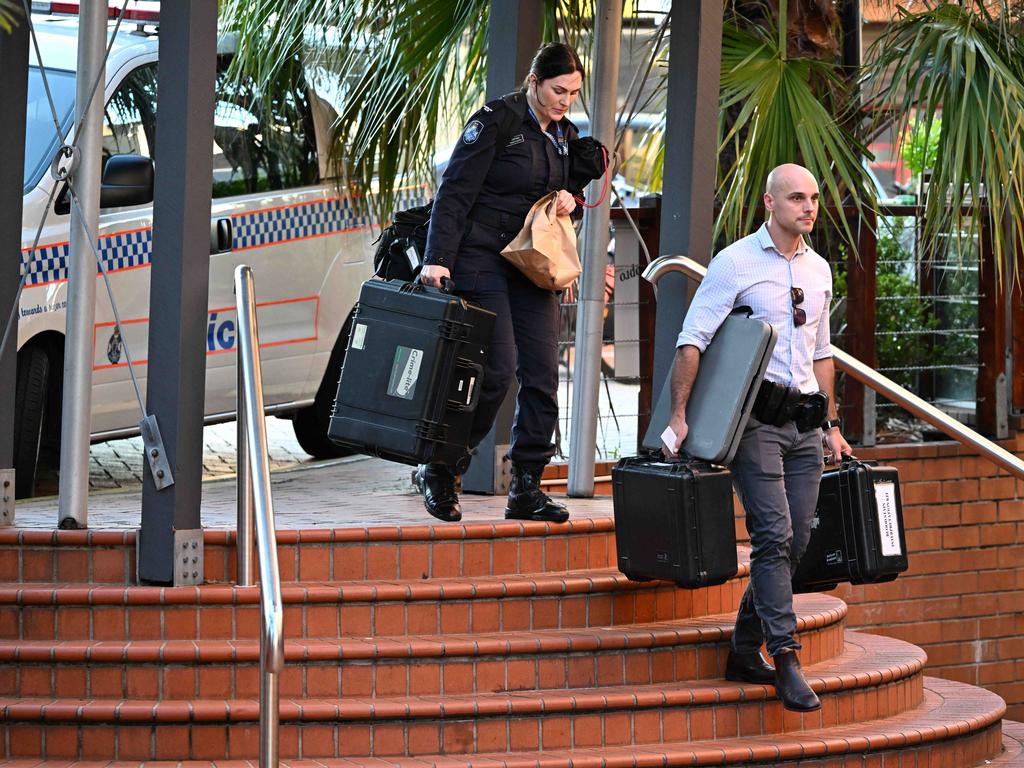 Police and forensic officers at the scene of the apartment. Picture: Lyndon Mechielsen/Courier Mail