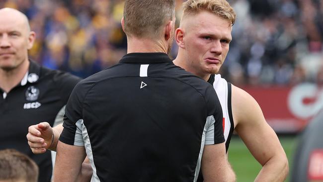 Dejected Adam Treloar and Collingwood coach Nathan Buckley