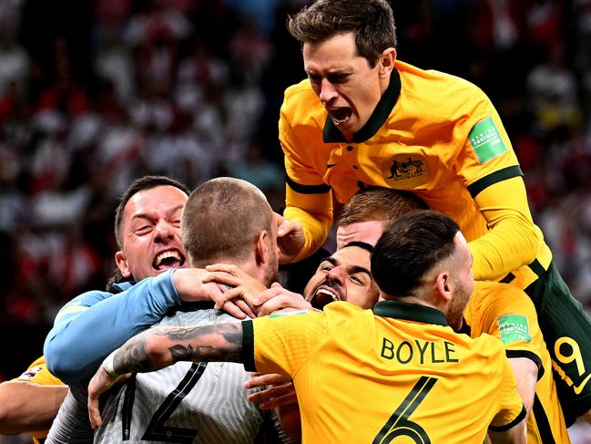 DOHA, QATAR - JUNE 13: Australia celebrate after defeating Peru in the 2022 FIFA World Cup Playoff match between Australia Socceroos and Peru at Ahmad Bin Ali Stadium on June 13, 2022 in Doha, Qatar. (Photo by Joe Allison/Getty Images)