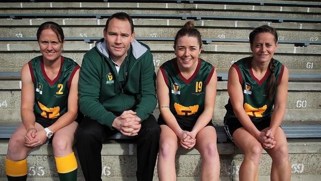 Tasmanian female footballers, such as Sandy Eaton, Jessica Wuetschner and Deb Allen seen here with coach Trent Bartlee, might not have to head interstate from 2019 to play in the AFLW.