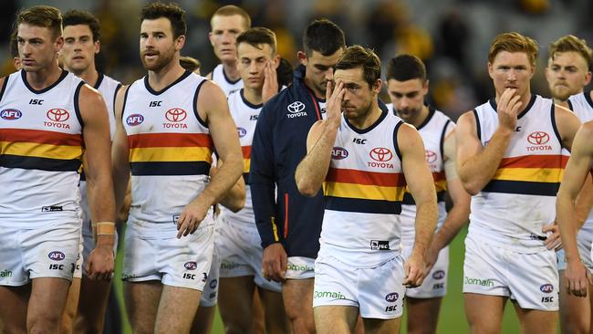 Crows players leave the ground after the loss to Hawthorn.