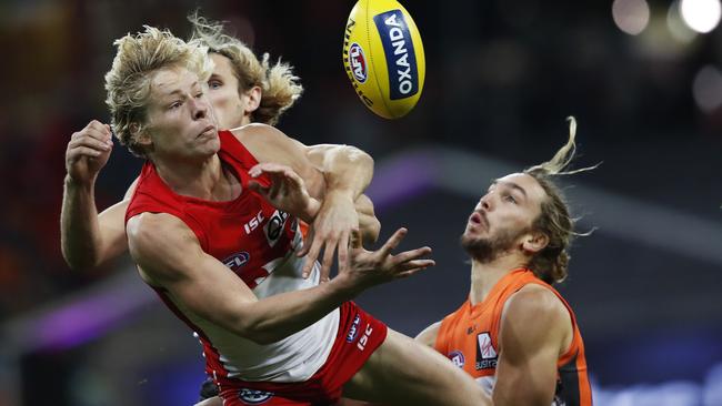 Sydney's Isaac Heeney spoiled by Giants Nick Haynes and Matt Buntine during AFL match GWS Giants v Sydney Swans at Spotless Stadium. Picture. Phil Hillyard