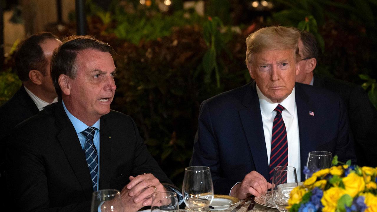 US President Donald Trump (right) speaks with Brazilian President Jair Bolsonaro during a dinner at Mar-a-Lago in Palm Beach, Florida, on March 7, 2020. Picture: Jim Watson / AFP.